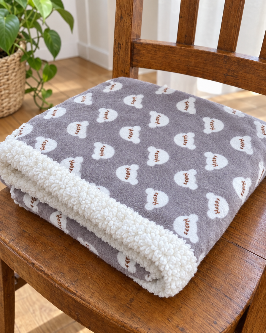 Plaid gris imprimé avec bordure sherpa plié